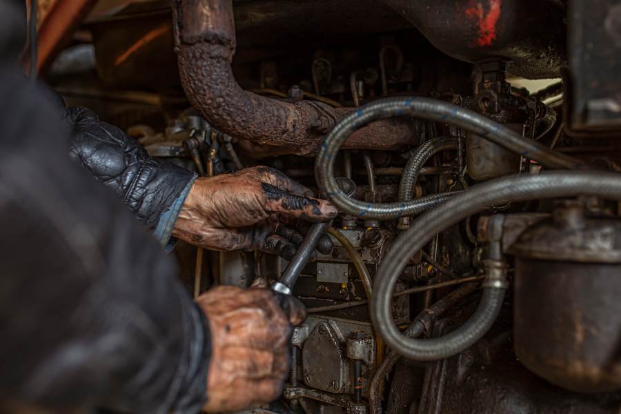 man working on tractor