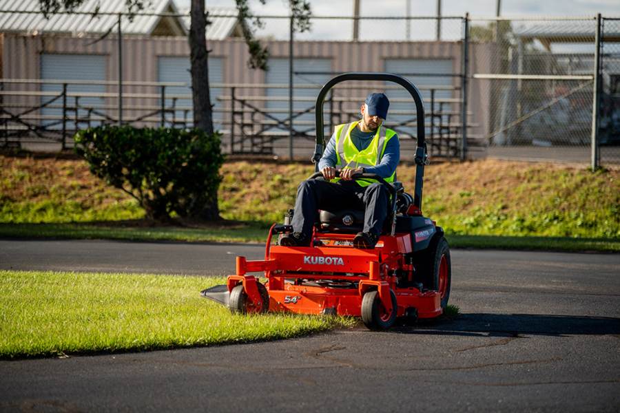 A Kubota commercial mower mowing grass.