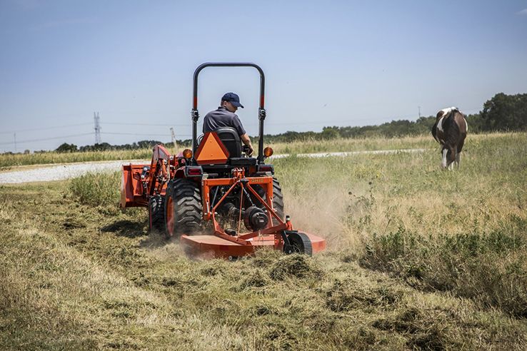 Man riding tractor mower.
