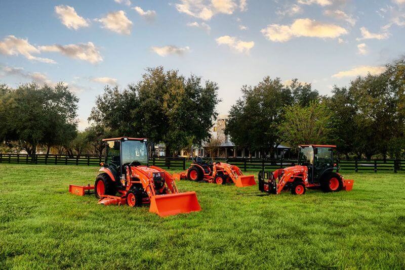 three Kubota tractors from Mission Valley Kubota in grass field