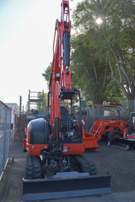 Kubota tractor by equipment and trees by Mission Valley Kubota