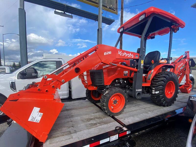 Kubota tractor on trailer by Mission Valley Kubota